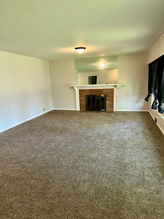 207 Dodge Ave, Danville, IL 61832 - unfurnished living room featuring a glass covered fireplace and carpet