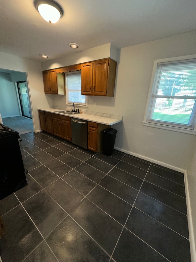 207 Dodge Ave, Danville, IL 61832 - kitchen with dishwasher, black range with electric cooktop, dark tile patterned flooring, light countertops, and brown cabinets