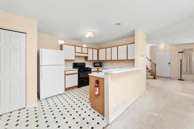 43 Freesia Ct, Romeoville, IL 60446 - kitchen with freestanding refrigerator, black gas range oven, light countertops, a peninsula, and under cabinet range hood