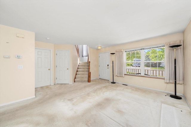 43 Freesia Ct, Romeoville, IL 60446 - unfurnished living room featuring stairway and carpet flooring