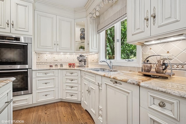 85 Ela Rd, Inverness, IL 60067 - kitchen with stainless steel double oven, backsplash, white cabinetry, and light stone countertops