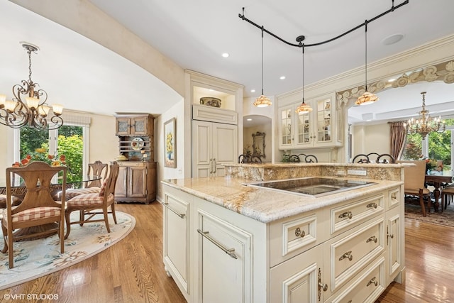 85 Ela Rd, Inverness, IL 60067 - kitchen with a chandelier, black electric cooktop, glass insert cabinets, light wood-style floors, and recessed lighting