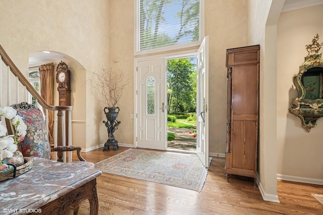 85 Ela Rd, Inverness, IL 60067 - entryway with arched walkways, a high ceiling, wood finished floors, and stairs