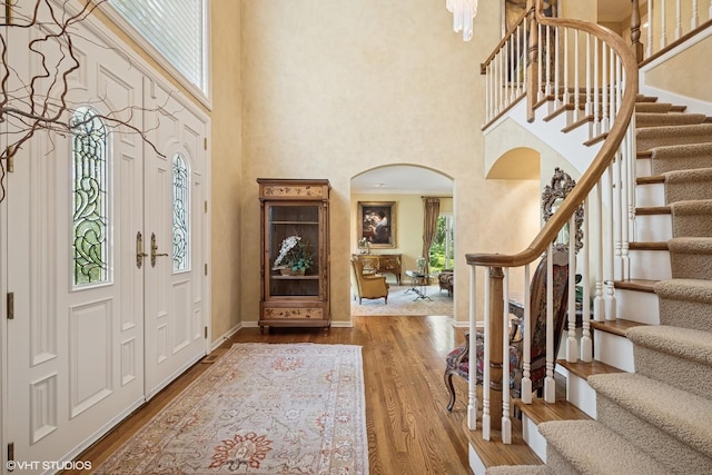 85 Ela Rd, Inverness, IL 60067 - entrance foyer featuring a high ceiling, arched walkways, stairs, and wood finished floors