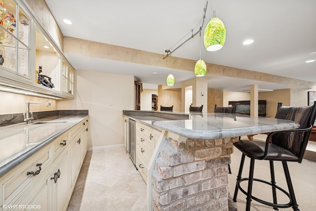 85 Ela Rd, Inverness, IL 60067 - kitchen with a kitchen bar, glass insert cabinets, wine cooler, open floor plan, and pendant lighting