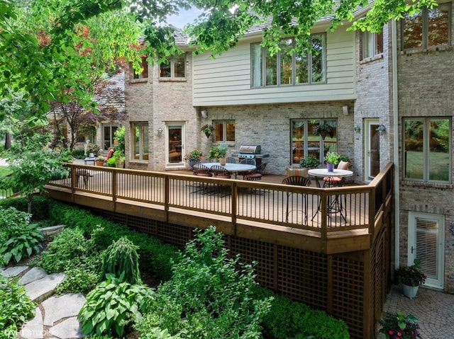 85 Ela Rd, Inverness, IL 60067 - rear view of house with a wooden deck, brick siding, and outdoor dining area