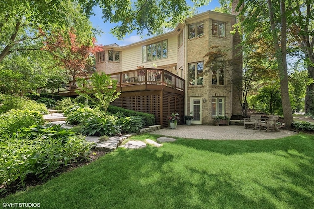 85 Ela Rd, Inverness, IL 60067 - back of property featuring a lawn, a wooden deck, a patio, and brick siding