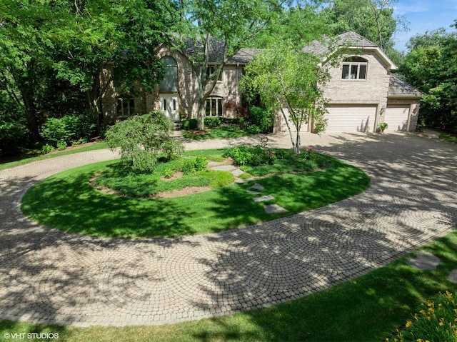 85 Ela Rd, Inverness, IL 60067 - obstructed view of property with curved driveway and a garage