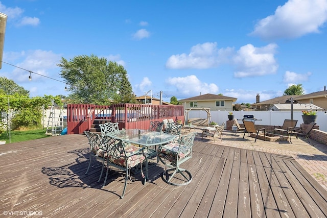 8437 167th St, Tinley Park, IL 60487 - wooden terrace with a fire pit, outdoor dining area, and a fenced backyard
