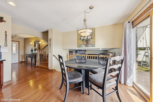8437 167th St, Tinley Park, IL 60487 - dining space featuring arched walkways, light wood-style floors, and stairway