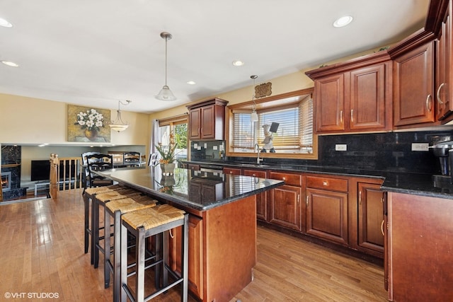 8437 167th St, Tinley Park, IL 60487 - kitchen with backsplash, light wood-type flooring, a kitchen bar, recessed lighting, and a kitchen island