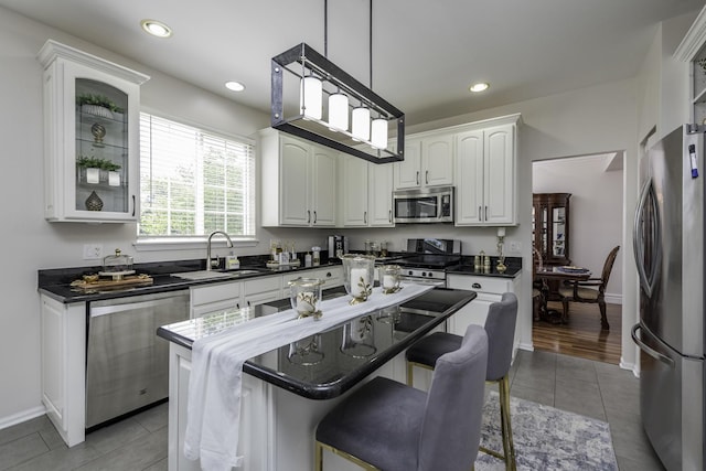 1650 Natures Way, Lindenhurst, IL 60046 - kitchen featuring appliances with stainless steel finishes, dark countertops, white cabinetry, glass insert cabinets, and recessed lighting