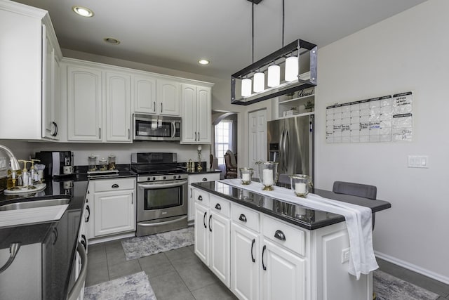 1650 Natures Way, Lindenhurst, IL 60046 - kitchen with stainless steel appliances, dark countertops, white cabinets, a center island, and recessed lighting