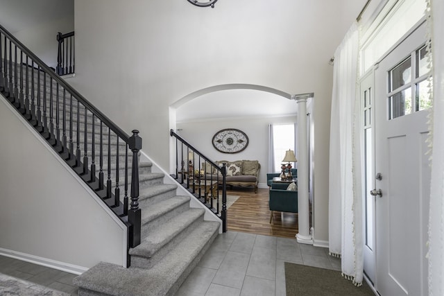 1650 Natures Way, Lindenhurst, IL 60046 - tiled foyer with decorative columns, arched walkways, a high ceiling, stairs, and ornamental molding