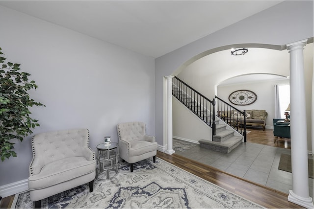 1650 Natures Way, Lindenhurst, IL 60046 - sitting room with decorative columns, arched walkways, wood finished floors, and stairs