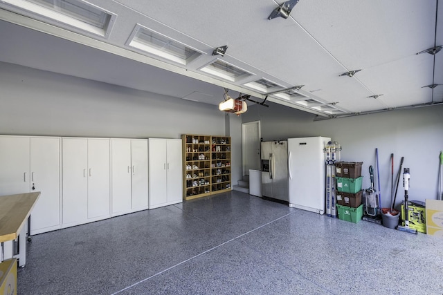 1650 Natures Way, Lindenhurst, IL 60046 - garage with stainless steel fridge with ice dispenser, freestanding refrigerator, and a garage door opener