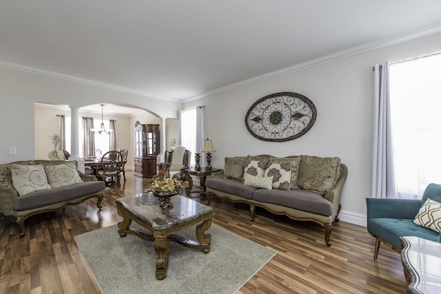 1650 Natures Way, Lindenhurst, IL 60046 - living room featuring arched walkways, a chandelier, crown molding, wood finished floors, and ornate columns