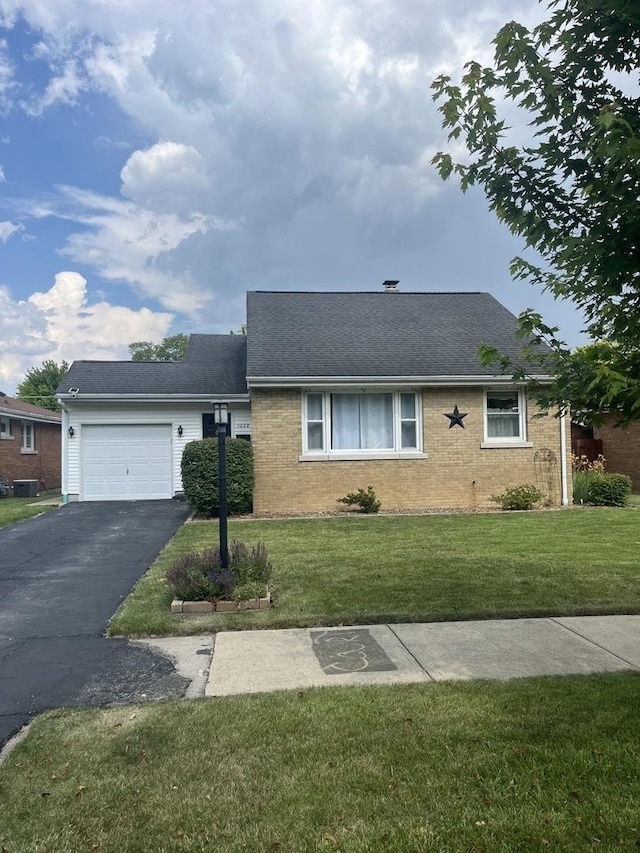 1620 S 5th Ave, Kankakee, IL 60901 - view of front of home featuring an attached garage, a front yard, driveway, and brick siding
