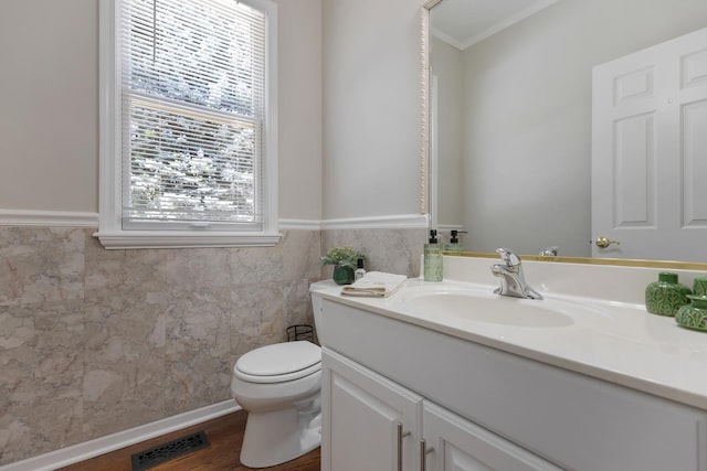 262 Hawk Hollow Dr, Bartlett, IL 60103 - half bathroom with vanity, wainscoting, ornamental molding, and wood finished floors