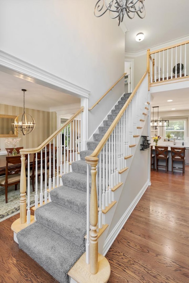 262 Hawk Hollow Dr, Bartlett, IL 60103 - stairs featuring a chandelier, ornamental molding, wood finished floors, and a high ceiling