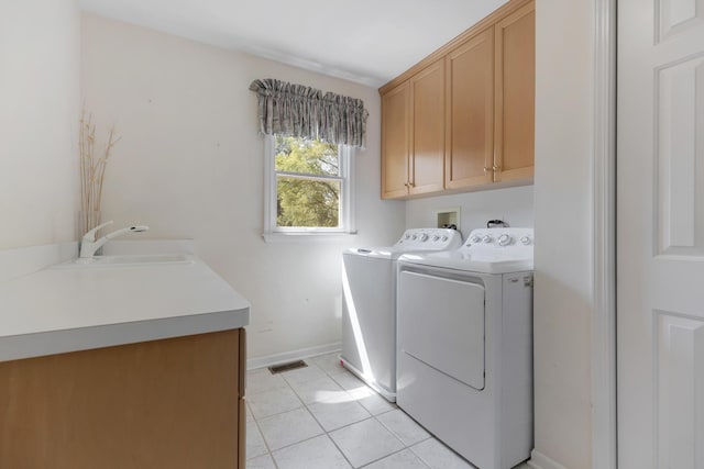 262 Hawk Hollow Dr, Bartlett, IL 60103 - laundry area with cabinet space, washing machine and dryer, and light tile patterned flooring