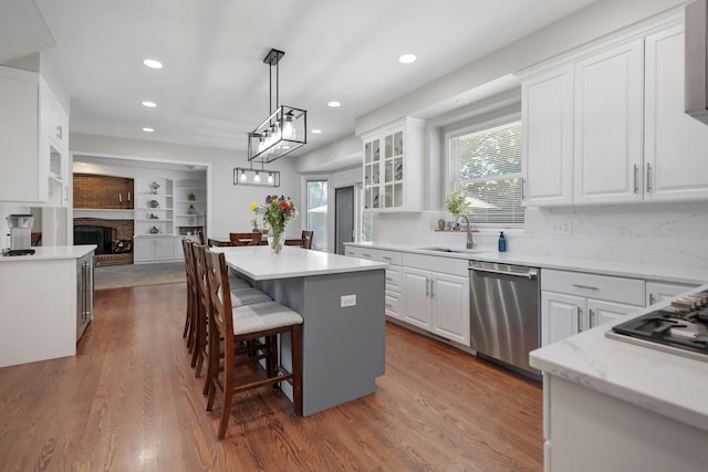 262 Hawk Hollow Dr, Bartlett, IL 60103 - kitchen featuring appliances with stainless steel finishes, a center island, white cabinets, recessed lighting, and glass insert cabinets