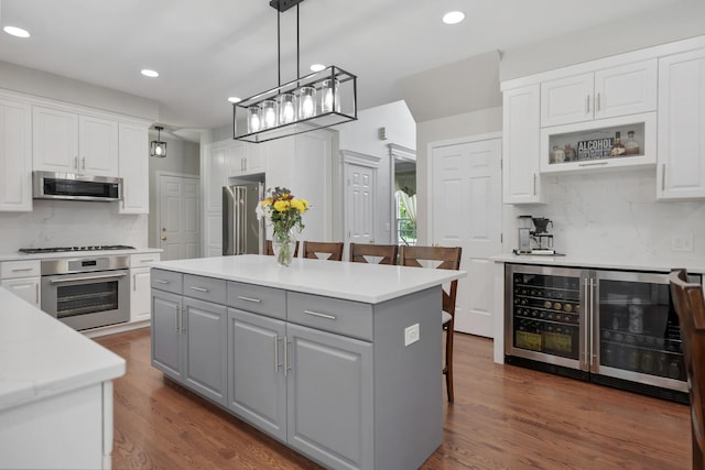 262 Hawk Hollow Dr, Bartlett, IL 60103 - kitchen with stainless steel appliances, gray cabinets, beverage cooler, white cabinetry, and recessed lighting