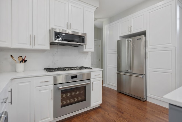 262 Hawk Hollow Dr, Bartlett, IL 60103 - kitchen featuring appliances with stainless steel finishes, white cabinets, light countertops, tasteful backsplash, and dark wood finished floors