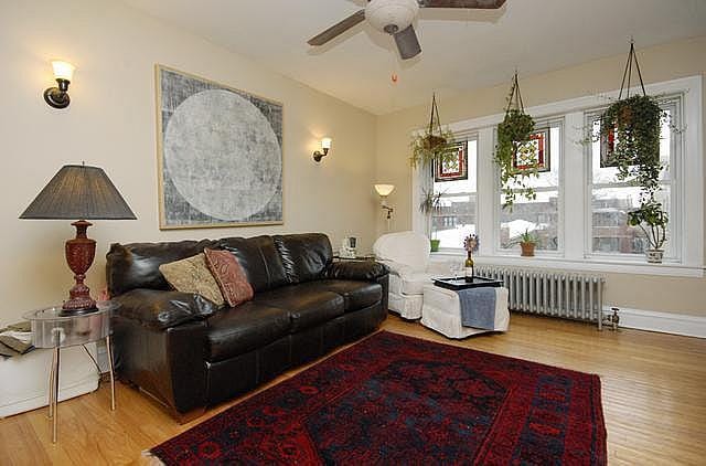 3135 W Leland Ave Unit 3W, Chicago, IL 60625 - living room with radiator, wood finished floors, and ceiling fan