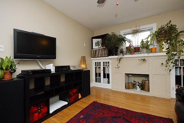 3135 W Leland Ave Unit 3W, Chicago, IL 60625 - living area featuring ceiling fan, wood finished floors, and a fireplace
