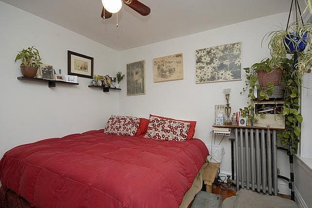 3135 W Leland Ave Unit 3W, Chicago, IL 60625 - bedroom with radiator heating unit, carpet floors, and a ceiling fan