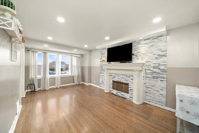 8020 S Mozart St, Chicago, IL 60652 - unfurnished living room with a stone fireplace, wood finished floors, and recessed lighting