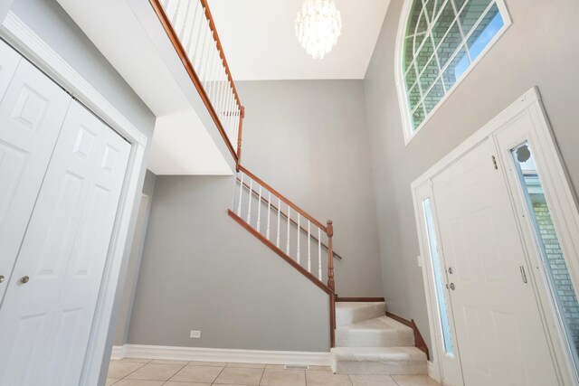 441 Wheeler Dr, Lemont, IL 60439 - entryway with stairs, a chandelier, light tile patterned floors, and a towering ceiling