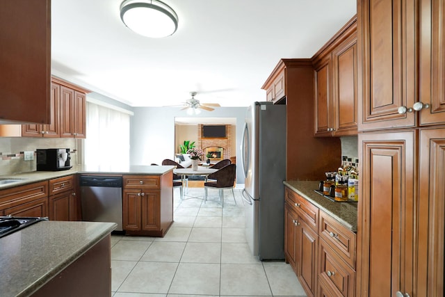 441 Wheeler Dr, Lemont, IL 60439 - kitchen with appliances with stainless steel finishes, ceiling fan, backsplash, and brown cabinetry