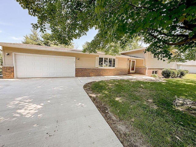 202 E 8th St, Gridley, IL 61744 - tri-level home with brick siding, concrete driveway, an attached garage, and a front yard