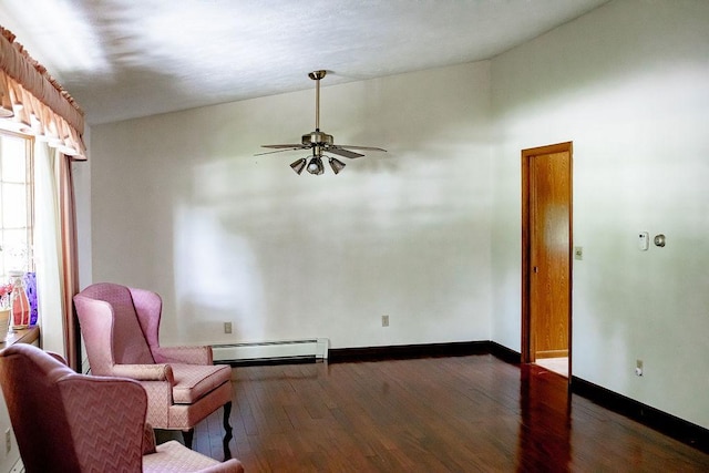 202 E 8th St, Gridley, IL 61744 - living area with a baseboard radiator, a ceiling fan, and dark wood-style flooring