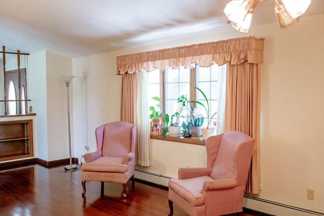202 E 8th St, Gridley, IL 61744 - living area with a baseboard radiator, wood finished floors, and ceiling fan