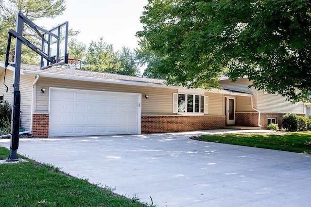 202 E 8th St, Gridley, IL 61744 - tri-level home with brick siding, concrete driveway, and a garage