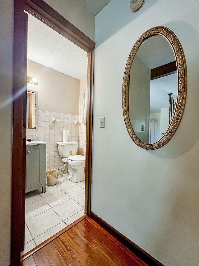 202 E 8th St, Gridley, IL 61744 - bathroom featuring tile walls, wood finished floors, and vanity