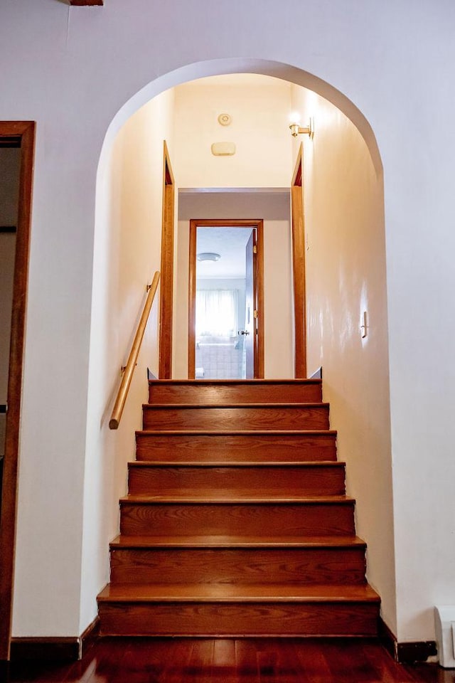 202 E 8th St, Gridley, IL 61744 - staircase featuring arched walkways and wood finished floors