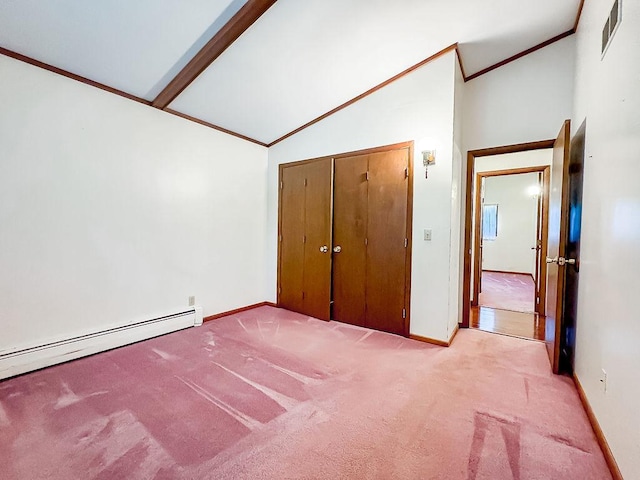 202 E 8th St, Gridley, IL 61744 - unfurnished bedroom featuring light carpet, vaulted ceiling, ornamental molding, a baseboard radiator, and a closet