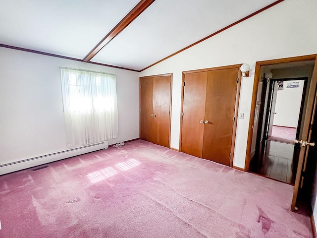 202 E 8th St, Gridley, IL 61744 - unfurnished bedroom with multiple closets, light carpet, a baseboard heating unit, and ornamental molding