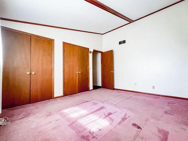 202 E 8th St, Gridley, IL 61744 - unfurnished bedroom with two closets, vaulted ceiling, and carpet