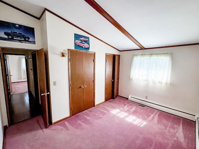 202 E 8th St, Gridley, IL 61744 - unfurnished bedroom featuring a baseboard radiator, vaulted ceiling, ornamental molding, carpet, and multiple closets
