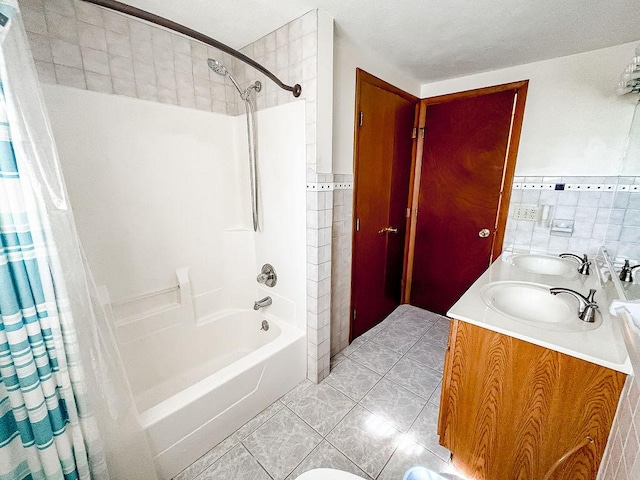202 E 8th St, Gridley, IL 61744 - full bathroom with tile walls, shower / bath combo with shower curtain, double vanity, and tile patterned flooring