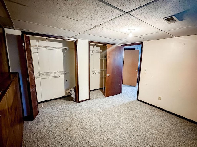 202 E 8th St, Gridley, IL 61744 - unfurnished bedroom featuring carpet, two closets, and a drop ceiling