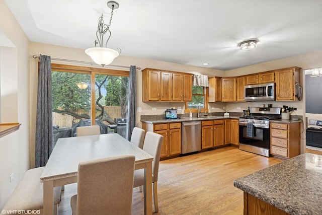 1177 Dovercliff Way, Crystal Lake, IL 60014 - kitchen with appliances with stainless steel finishes, light wood finished floors, plenty of natural light, and brown cabinets