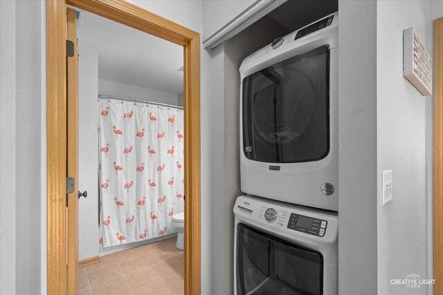 307 Gregory Ln, Plano, IL 60545 - laundry room with stacked washing machine and dryer and tile patterned flooring
