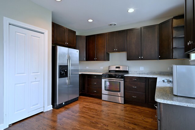 315 N Ridgeland Ave, Elmhurst, IL 60126 - kitchen with appliances with stainless steel finishes, dark brown cabinetry, dark wood-style flooring, open shelves, and light stone countertops