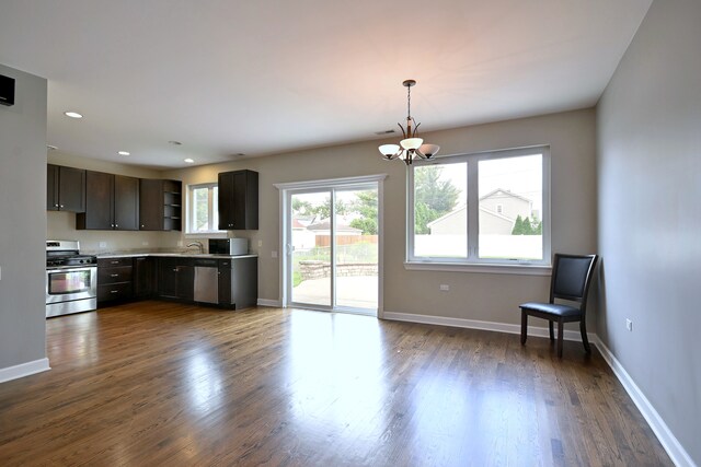 315 N Ridgeland Ave, Elmhurst, IL 60126 - kitchen featuring appliances with stainless steel finishes, a chandelier, dark wood-style floors, light countertops, and hanging light fixtures